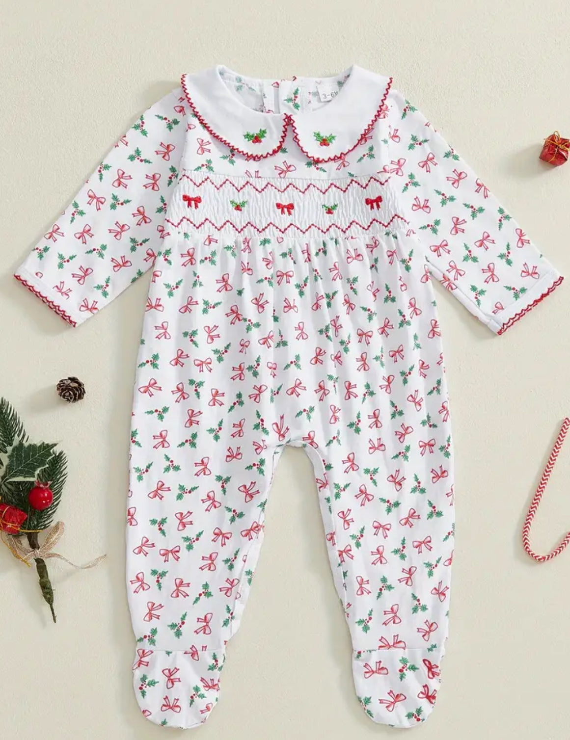 Holly & bows smocked sleep suit